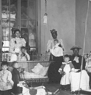 [Glass Lantern Slide Showing African American Women Caretakers in a Day Nursery with White Children].