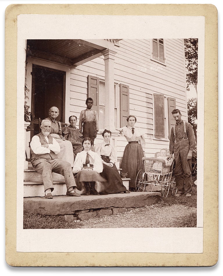 [3730865] Ca. 1890s vernacular photograph of a white family on a porch with an African American boy. Unkwn.